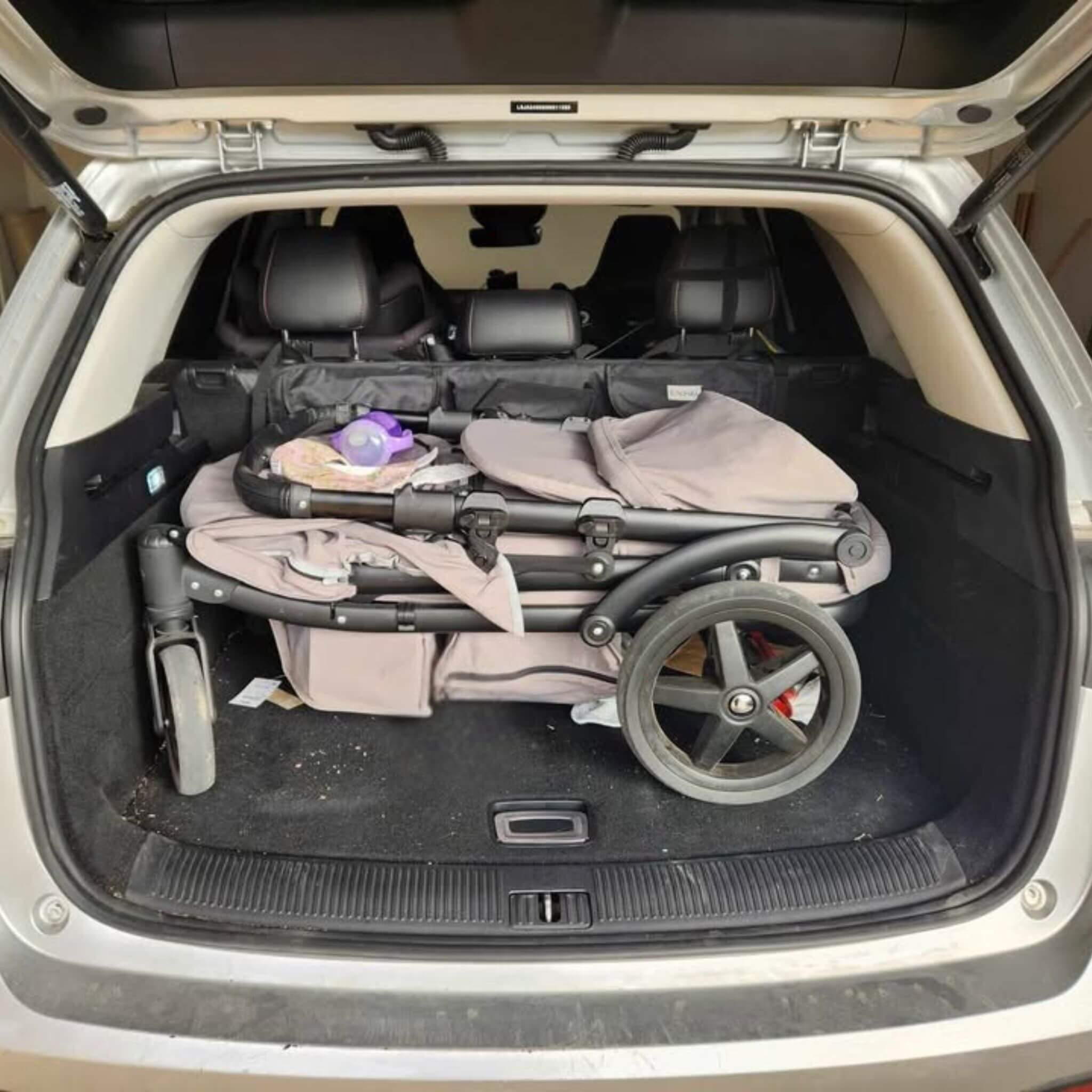 Open car boot with a folded pronto stroller inside